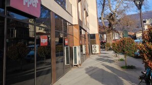 A modern building with a 'kipper' sign, large windows, and a clear sky. - Wohnung "Stefea Center Apart" by Interhome (Ohrid)