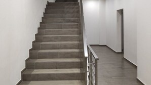 A staircase with a handrail leading to a dark doorway at the top. - Wohnung "Stefea Center Apart" by Interhome (Ohrid)