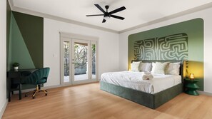 A bedroom with a bed, a desk, and a chair. There is a ceiling fan above the bed. - Casita W Stunning Views (Austin)