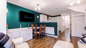 A modern apartment with a dining area, kitchen, and living space. - Spacious 3 bedroom home with garden (Buckshaw Village)