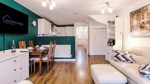 A modern apartment with a dining area, kitchen, and living room. - Spacious 3 bedroom home with garden (Buckshaw Village)