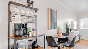 A kitchenette with a coffee machine, mugs, and a sign indicating wine o'clock. - Dockside Daydream Waterfront Next-To-Beach (Fort Walton Beach)