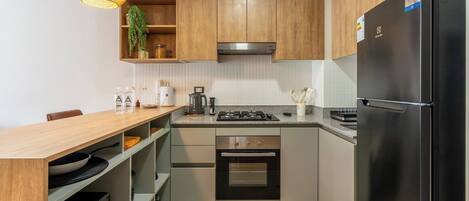 Fridge, microwave, coffee/tea maker, cookware/dishes/utensils