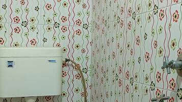 A bathroom with a toilet, a sink, and a shower.