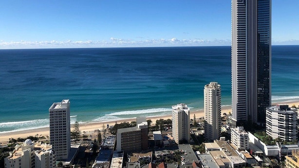 A coastal cityscape with high-rise buildings, a beach, and a clear blue sky. -  Mantra Towers of Chevron Holiday in Paradise (Surfers Paradise)