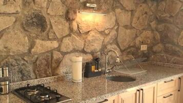 Een koelkast, een oven, kookgerei, borden en bestek