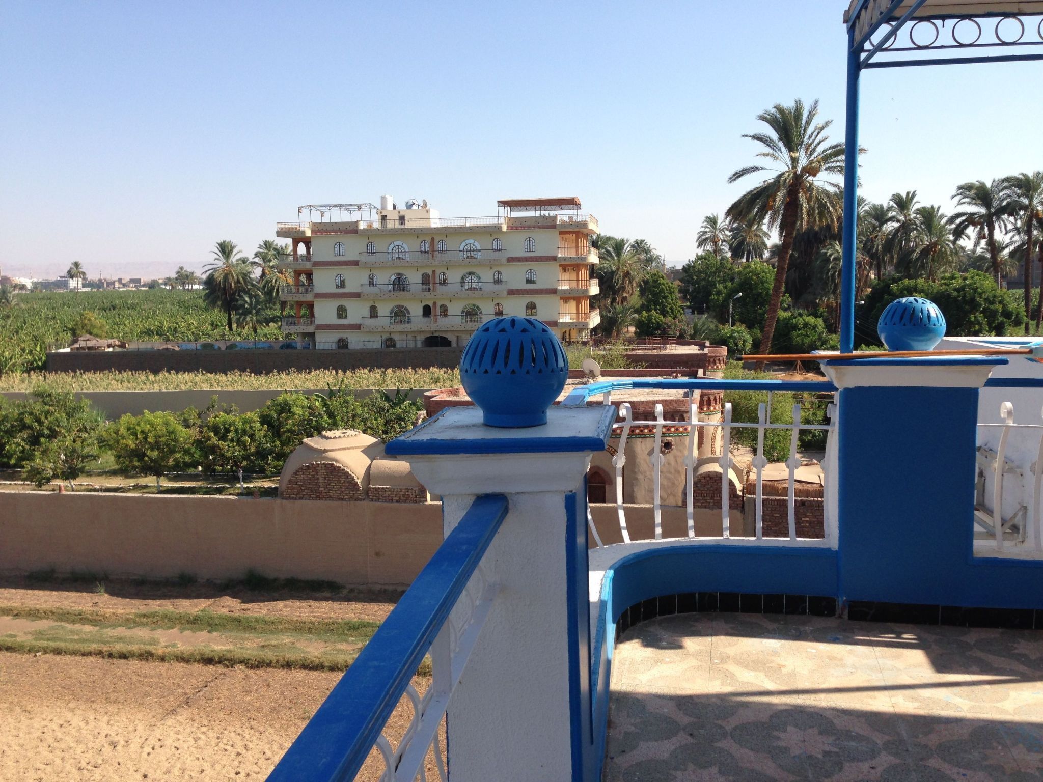 A building with a balcony and a blue and white railing.