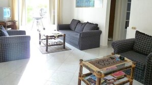 A living room with a sofa, a coffee table, and a television. - Fewo Riviera Sharm by Interhome (Sharm El Sheikh)