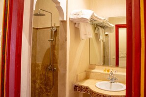 A bathroom with a shower, a sink, and a mirror. - Borj Des Cascades & Spa (Ait Taguella)