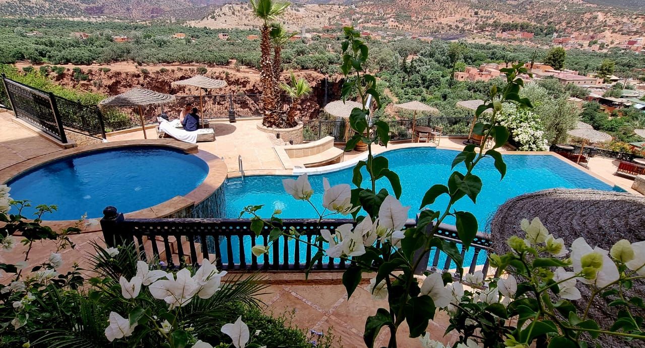 A pool area with a view of the surrounding landscape.
