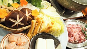 A variety of food items including bread, vegetables, and meat, arranged on a table.