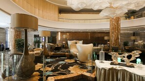 A spacious lobby with a high ceiling, elegant chandeliers, and a central seating area with modern chairs. - Guangzhou Vaperse Hotel Zhujiang Newtown (Guangzhou)