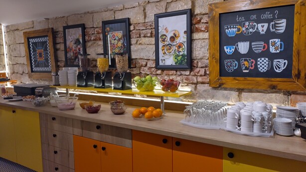 A breakfast buffet with various food items and drink dispensers. - Hotel S42 (Prague)