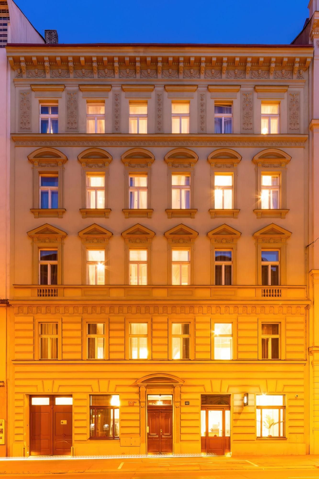 A multi-story building with a classic architectural style, featuring symmetrical windows and decorative moldings.