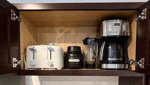 A kitchen with a built-in shelf holding a toaster, a blender, and a coffee maker. - New Duplex with King Bed and Easy Highway Access (Umatilla)