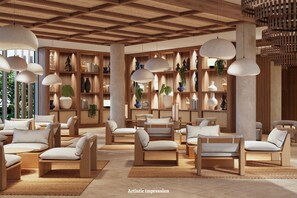 Un espace de détente moderne, doté de meubles en bois, d’un éclairage suspendu et de divers objets décoratifs disposés sur des étagères.