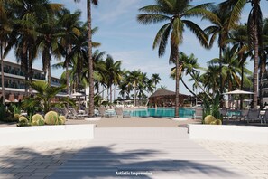Een zwembadgedeelte van een resort met palmbomen, ligbedden en een hut.