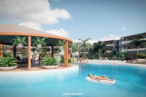 Een zwembadgedeelte met een lounge, palmbomen en een persoon die ontspant op een luchtbed.