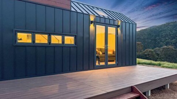 A modern house with a dark exterior, large windows, and a wooden deck. - Cinnabar Views - Jamieson (Jamieson)