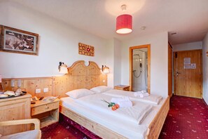 A hotel room with a wooden bed, bedside tables, a mirror, a shower, and a red carpet. - Hotel Relais Alpin Twin Room & Balcony7 237, Les Mosses, Switzerland (Les Mosses)