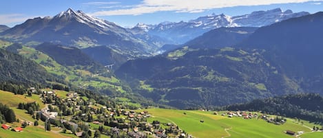 A mountainous landscape with a village nestled in the valley.