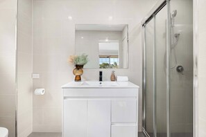Shower, hair dryer, towels, shampoo