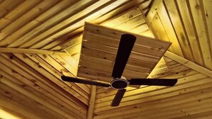 A ceiling with a wooden slat design and a central ceiling fan. - Neel Hawa Beach resort Saint Martin (Saint Martin's Island)