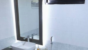 A bathroom with a white sink, mirror, and toilet. - Neel Hawa Beach resort Saint Martin (Saint Martin's Island)