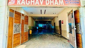 The entrance of Raghav Dharm with a sign indicating AC & Non-AC rooms. - Hotel Raghav Dham (Vrindavan)
