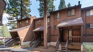 A modern multi-story building with wooden exterior and multiple staircases leading to the entrance. - Limited Time: 50% Off New Year's Week at Incline Village Club Tahoe (iNCLINE vILLAGE)