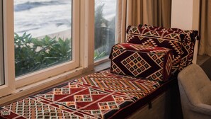 A window seat with a patterned cushion and a view of the ocean. - Villa Sayura by TONIK, Galle (Boossa)