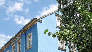 Sininen rakennus, jossa on useita ikkunoita ja kyltti, jossa lukee: ”BRIER Burotechnik”.