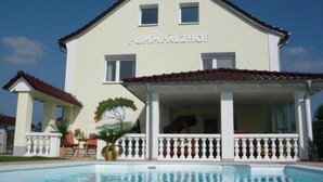 A two-story building with a pool in front, labeled "PUMPFACHER". - in Witzelroda mit Grill und Garten by Interhome (Moorgrund)