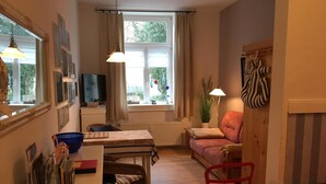 A cozy living room with a dining table, a sofa, and a TV. - Appartement in Wismar mit Terrasse und Garten by Interhome (Wismar)