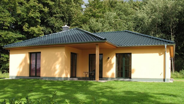 A single-story house with a flat roof, a covered porch, and a well-maintained lawn. - Wendorf by Interhome (Sanitz)