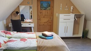 A bedroom with a wooden bed, a desk, and a wardrobe. - Schiemann by Interhome (Karnin)