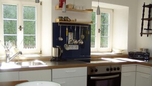 A kitchen with a wooden countertop, a stove, an oven, and a sink. - Ferienhaus by Interhome (Schernfeld)