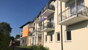 A multi-story residential building with balconies, a gated entrance, and a pathway leading to the entrance. - Ferienresidenz by Interhome (Bad Kötzting)