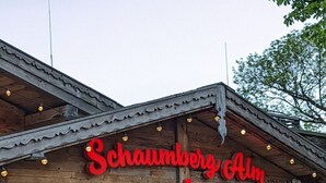 A rustic wooden building with a neon sign reading "Schaumberg Alm". - Schöndorf by Interhome (Tholey)