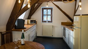 A kitchen with wooden beams, a window, and a refrigerator. - in Traben mit Kleinem Garten by Interhome (Traben-Trarbach)