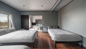 A modern hotel room with two beds, a small table, and a TV. - PROSTIMO (Bibai)