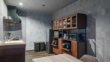 A modern kitchen with a wooden cabinet, stainless steel appliances, and a wooden dining table.