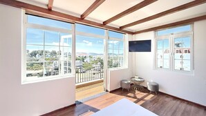 A room with large windows, a flat-screen TV, and a wooden ceiling. - KIEN DALAT (Lam Vien - Da Lat)