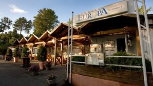 A traditional wooden building with a sign reading "EUROPA Feriendorf". - Belle Vue by Interhome (Husen)