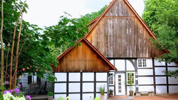 A traditional half-timbered building with a steeply pitched roof and a wooden facade. - An der Königstrasse by Interhome (Tecklenburg)