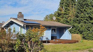 A single-story house with a sloped roof, solar panels, and a small porch. - Dachsbau by Interhome (Winsen / Aller)