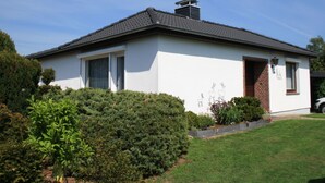 A single-story house with a white exterior and dark roof. - Ferienhaus by Interhome (Witzeeze)