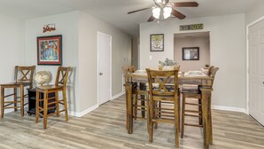 A dining area with a wooden table and chairs, a globe, and a tiger-themed sign. - 1 Mi to LSU, Tiger Stadium! Lovely Home w/ Parking (Baton Rouge)