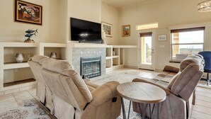 A spacious living room with a fireplace, comfortable seating, and a flat-screen TV. - Golf, Hike & Stargaze: Quiet Home in Las Cruces (Las Cruces)