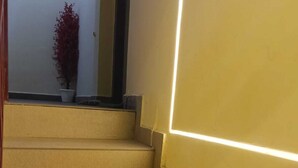 A set of beige carpeted stairs with a modern light strip on the wall. - SJ HOMES  (Changanassery)